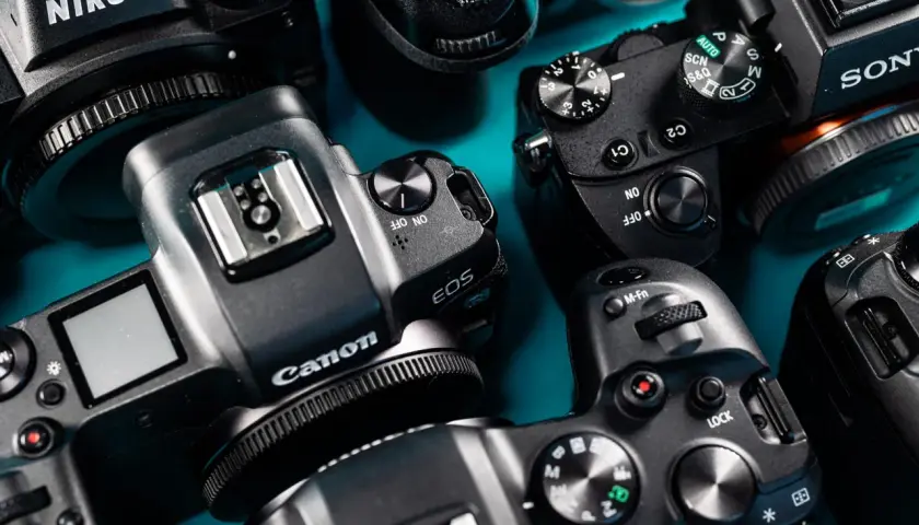 Kamera Nikon, Canon i Sony gotowe do sesji modowej. Zbliżenie na detale aparatów, przyciski i pokrętła.