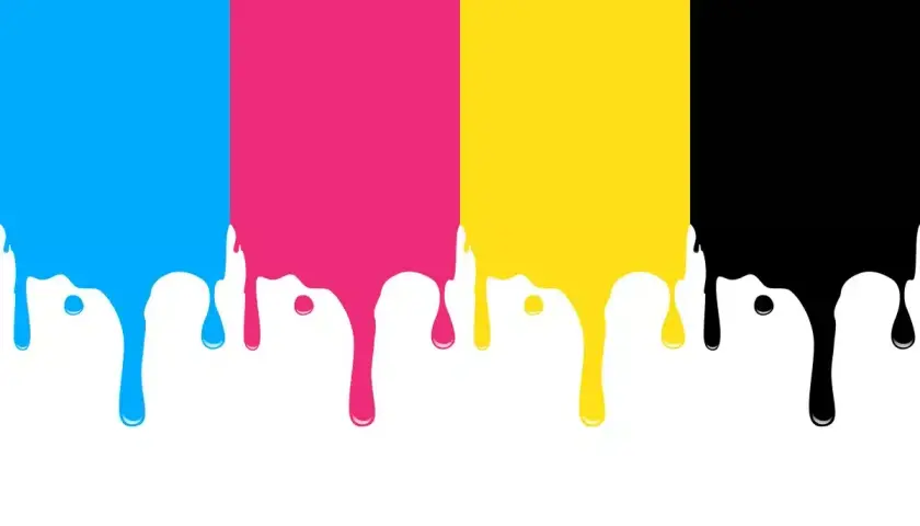 Kolory cmyk: cyjan, magenta, żółty i czarny spływają w dół, tworząc krople.
